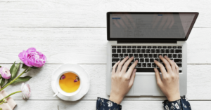 Woman typing on a laptop | Why now is the time to develop a writing strategy